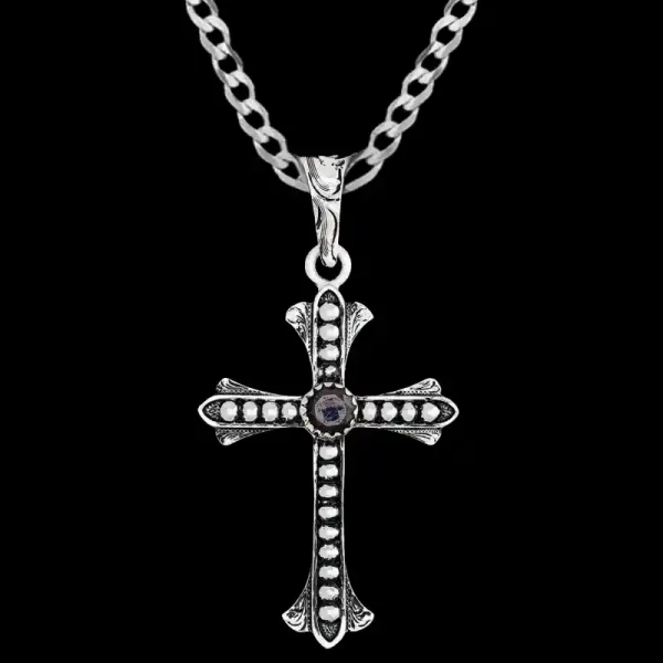 Customize the Génesis Cross Pendant: a 1.5"x2" German Silver cross with beaded and engraved details, finished with an antique touch. Choose your Cubic Zirconia color for a personal flair. 